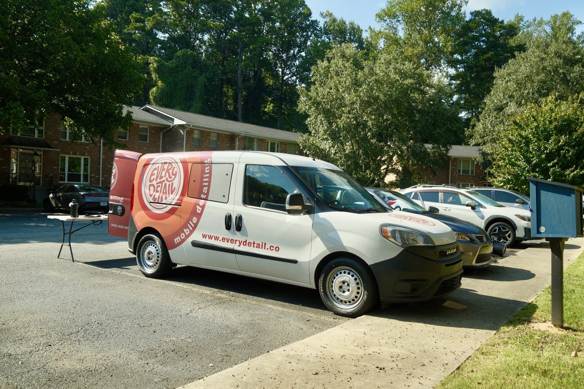 Every Detail mobile detailing vehicles lined up at a local job site