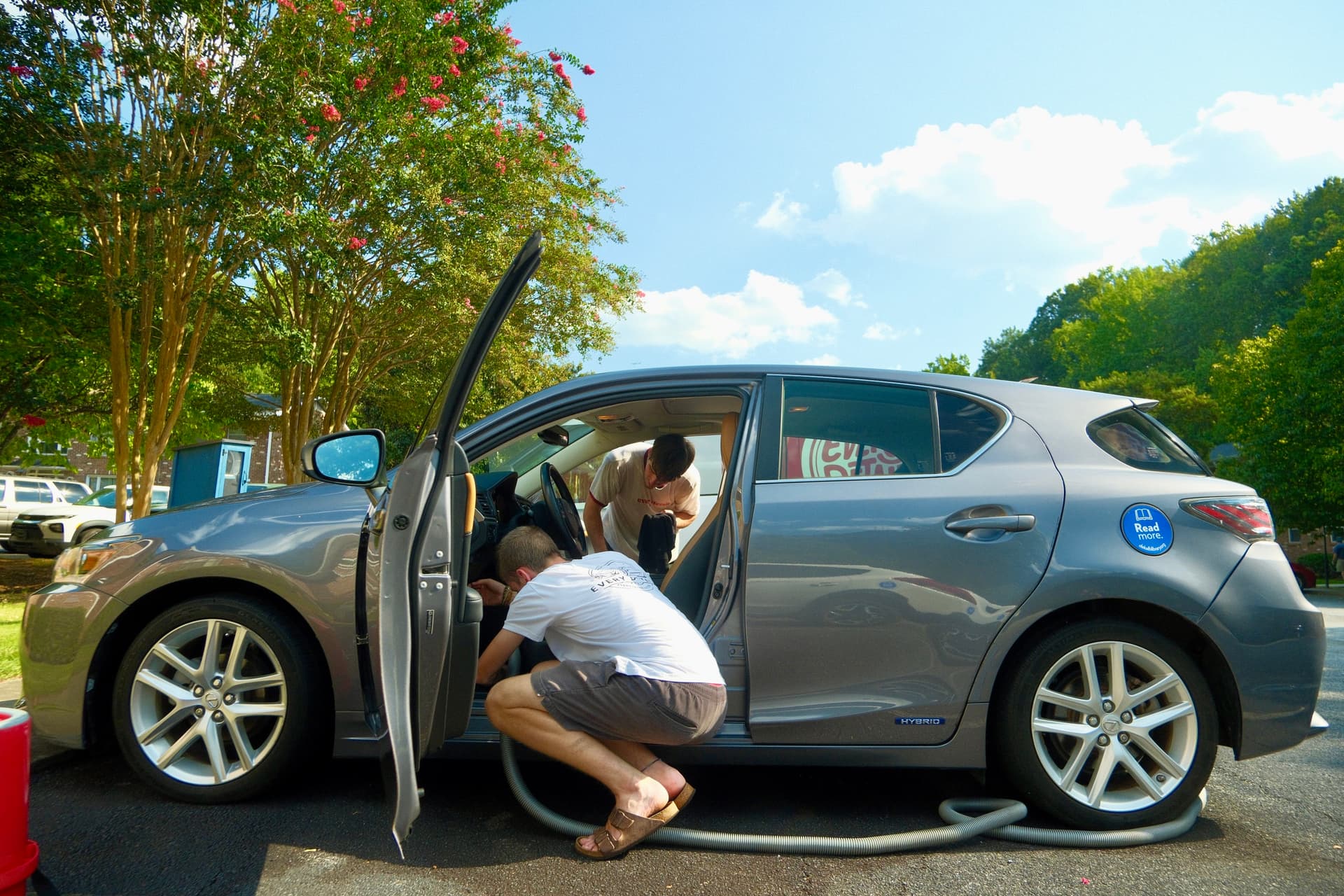 Two Every Detail technicians working together inside a customer vehicle