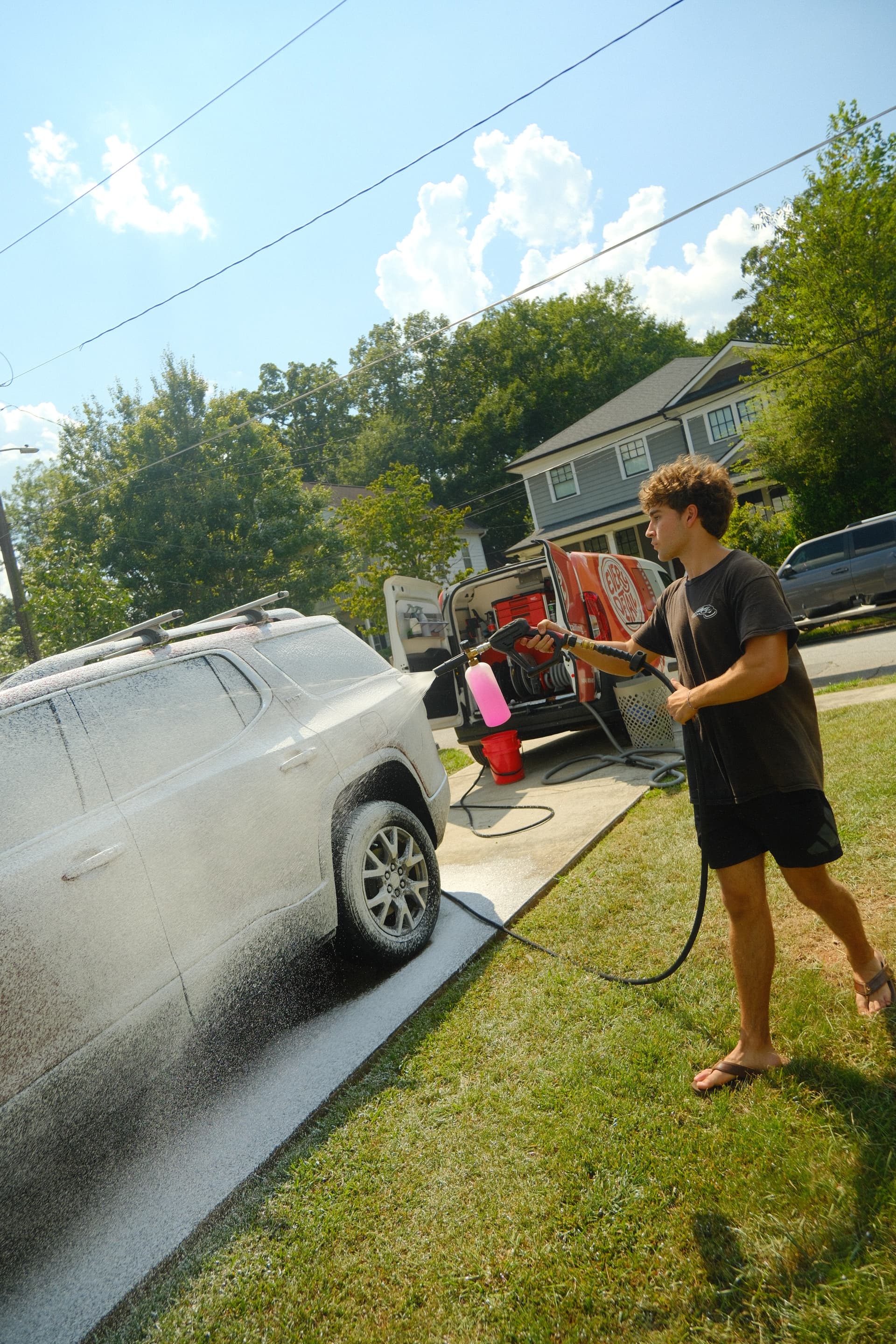 Every Detail technician Mateo foam washing a vehicle